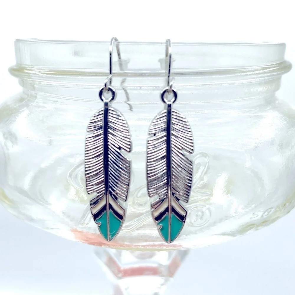 Boho Festival silver tone feather earrings with turquoise blue tips